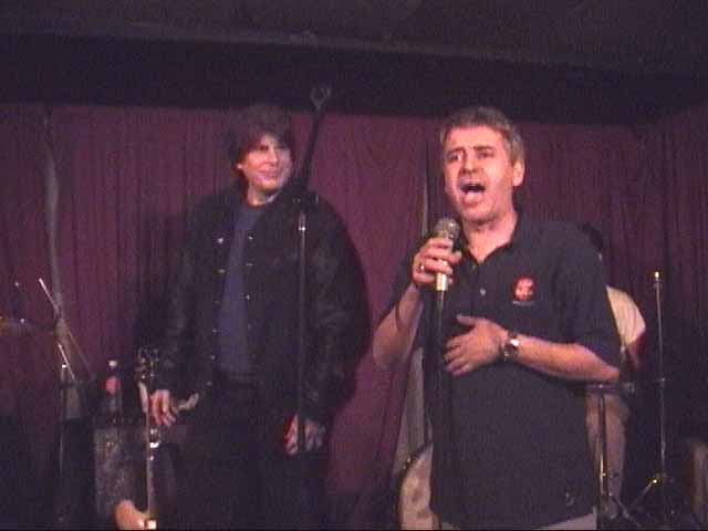 bartender addresses the crowd (Ronnie Mack in background)
